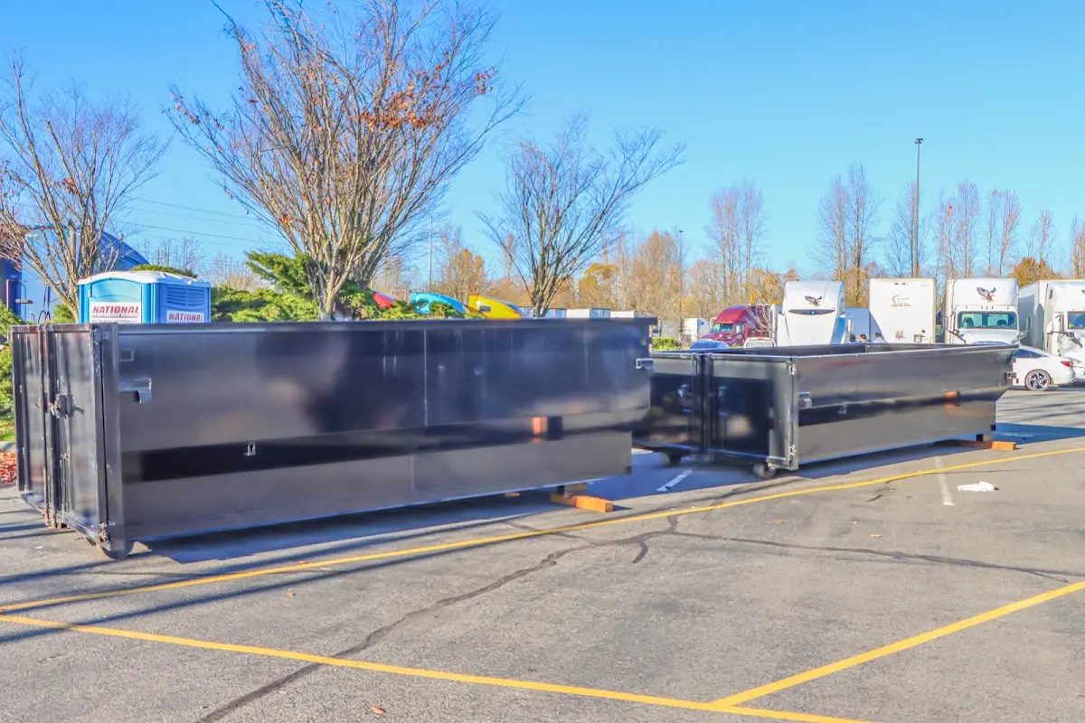 Professional dumpster rental service with roll-off container on residential driveway in Boise City